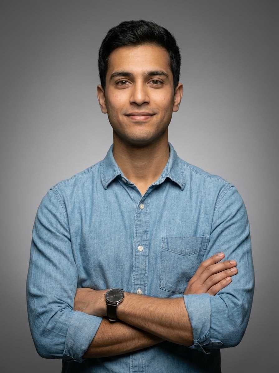 A confident young professional standing with arms crossed, ready for an interview